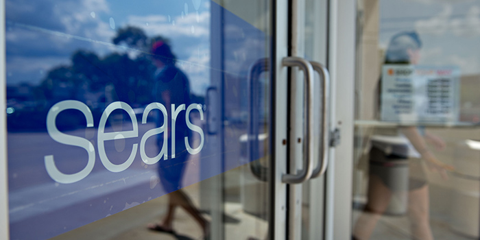 A shopper exits a Sears store in Peoria, Illinois, U.S., on Friday, Aug. 16, 2013. Sears Holdings Corp. is scheduled to release second quarter earnings on Aug. 22. Photographer: Daniel Acker/Bloomberg via Getty Images
